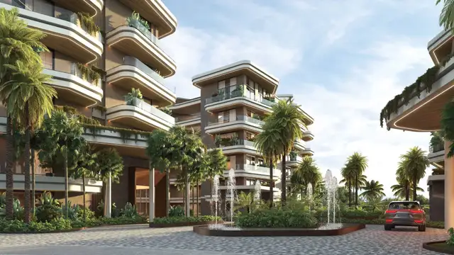 Entrance courtyard with fountain and palm trees between the ELITE Cap Cana buildings