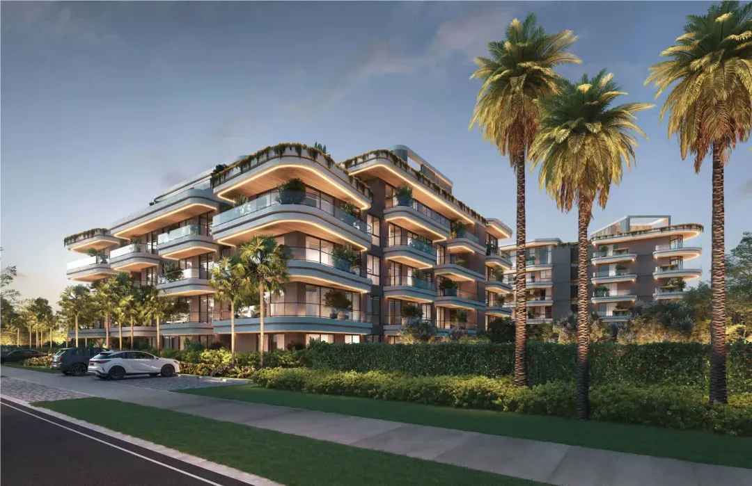 Facade of ELITE Cap Cana at dusk with palm trees and curved terraces, Cap Cana, Dominican Republic